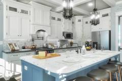 Kitchen space with coffered ceiling and modern island pendants