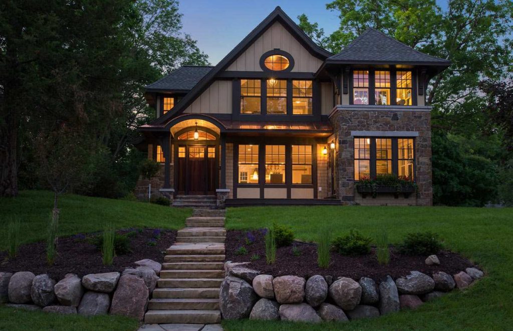 Home Design with stone siding and large windows.