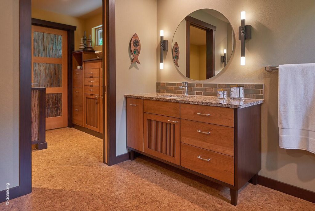 Photo of wood vanity and cork floor in large bathroom design by Robin Rigby Fisher