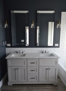 This white vanity and subway tile stand up to the deep blue walls in Danielle Burgers bathroom design.