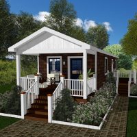 Tiny house design with front patio, decorative garden beds and dark shingle siding.