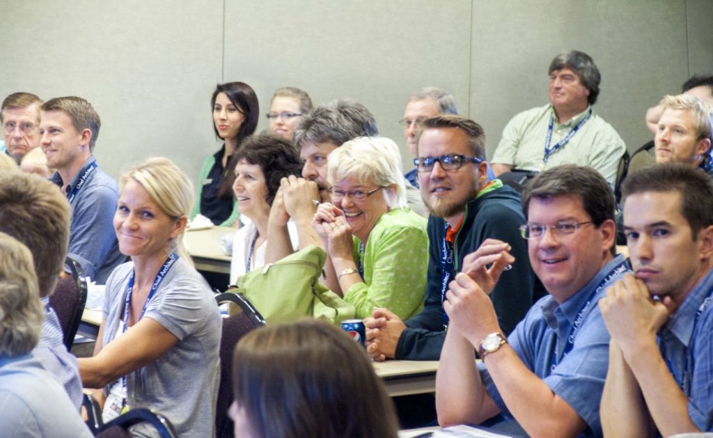 People smiling in a Chief Academy training class. 