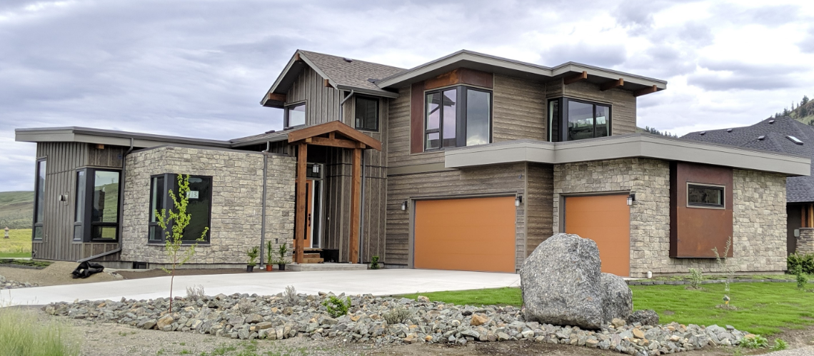 modern prairie style home surrounded by a golf course, desert hills and multiple views to Kamloops Lake