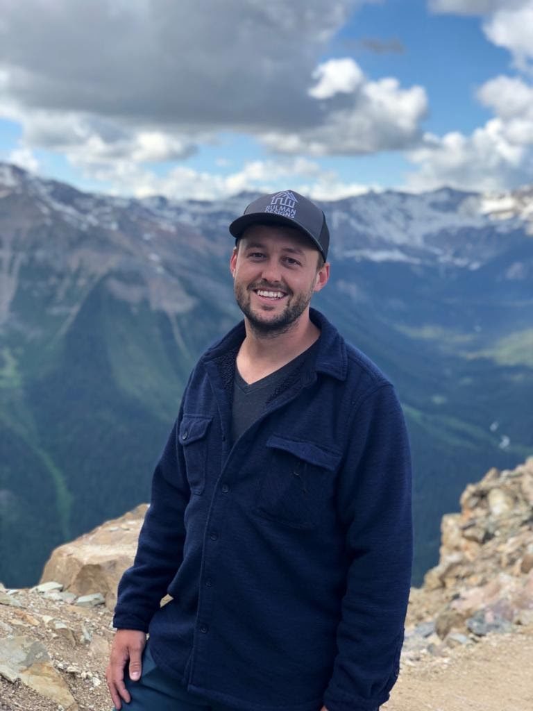 Photo of Sean Bulman standing on a mountain.