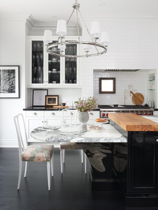 An interior featuring several design trends, including black cabinets, natural accents, dark wood flooring, and a soft feminine print. Interior designed by Estee Design