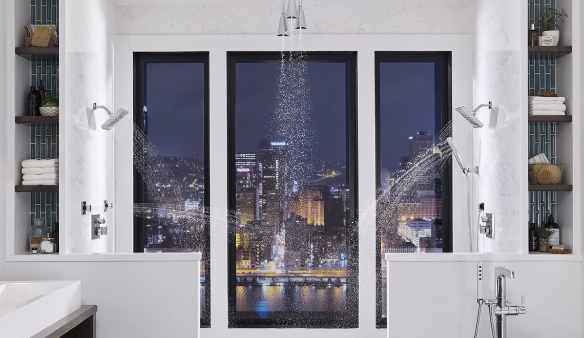 Luxurious shower with three shower heads and no-barrier entry.