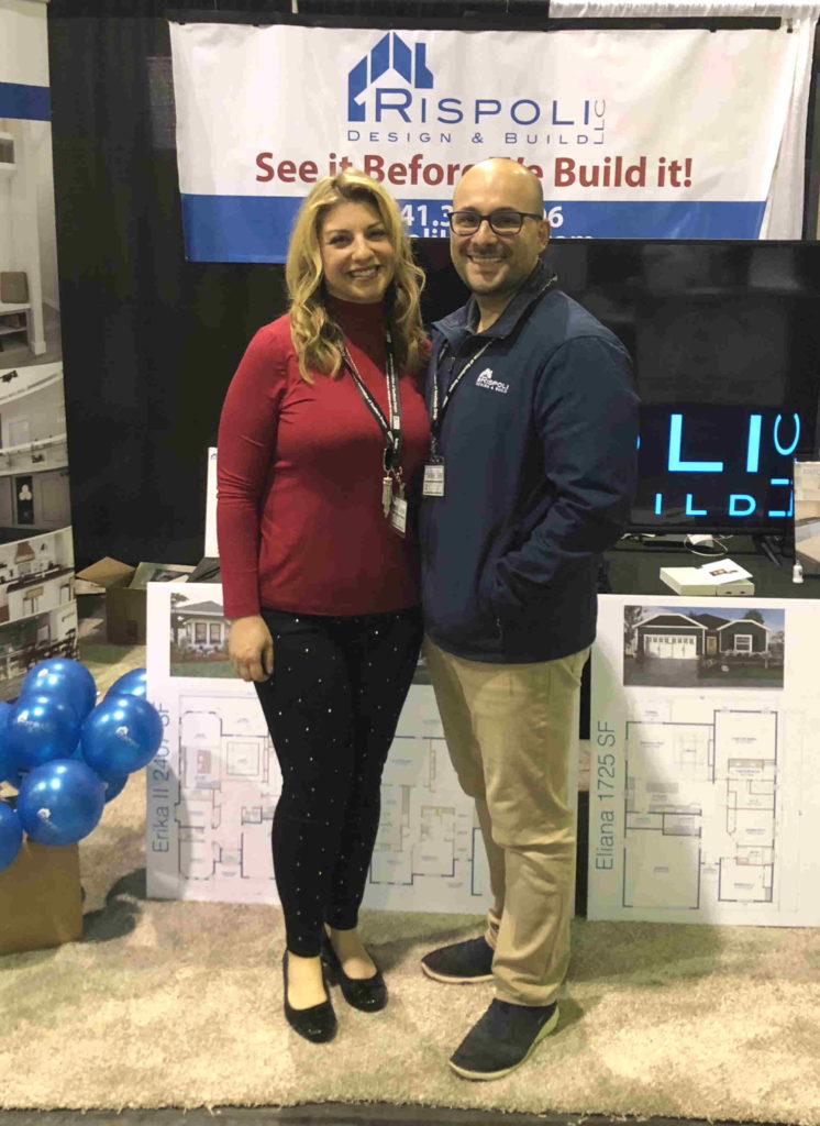 Man and woman standing side-by-side at tradeshow booth. 