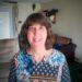 Head shot of woman in blue floral shirt.