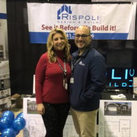 Man and woman standing side-by-side at tradeshow booth.