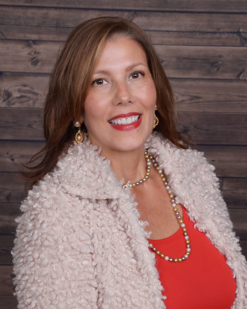 Woman with brown hair and red lipstick. 