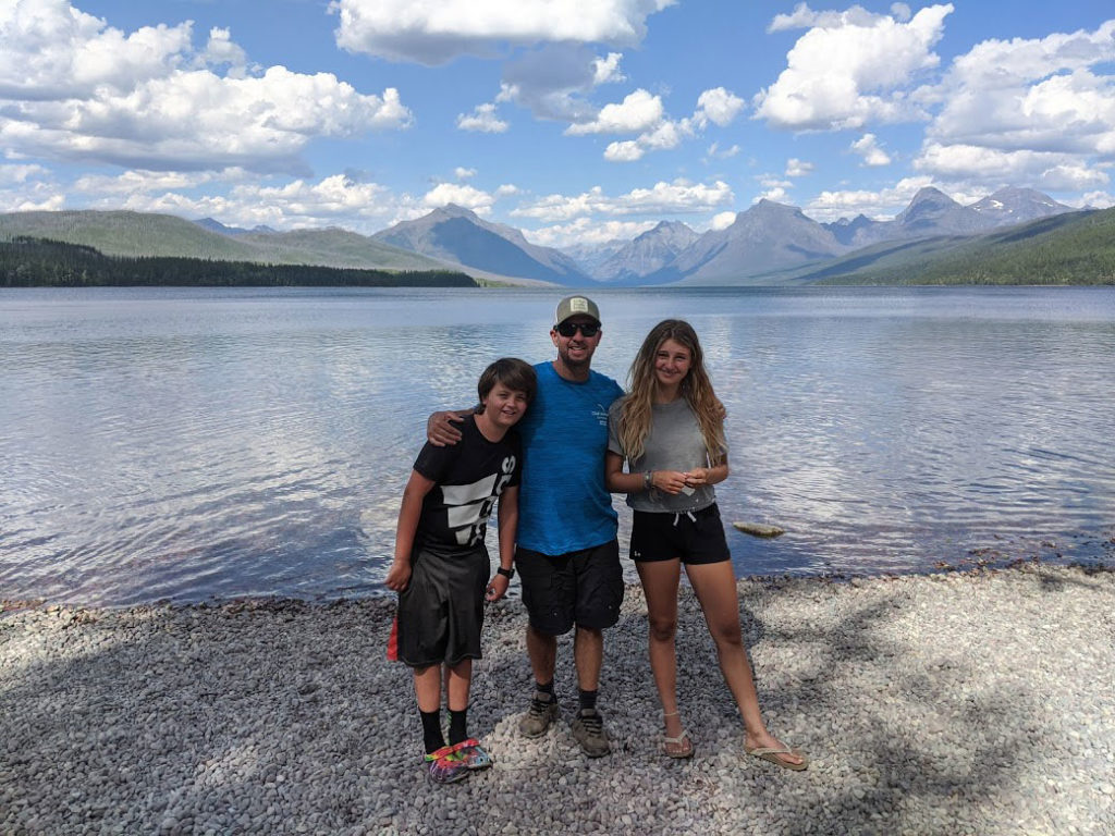 Family with mountain views in the background.