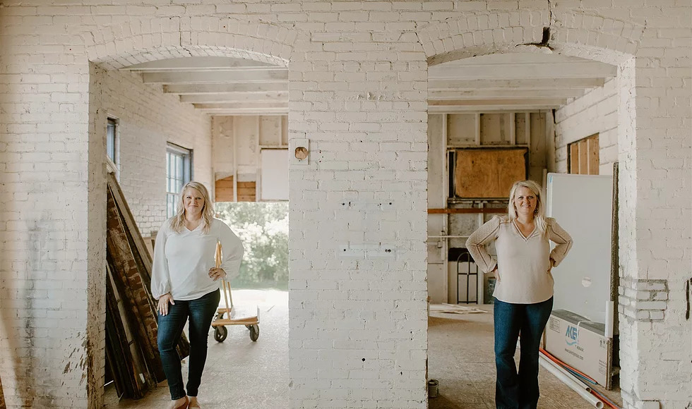 Kendra and Kerra under a brick double archway